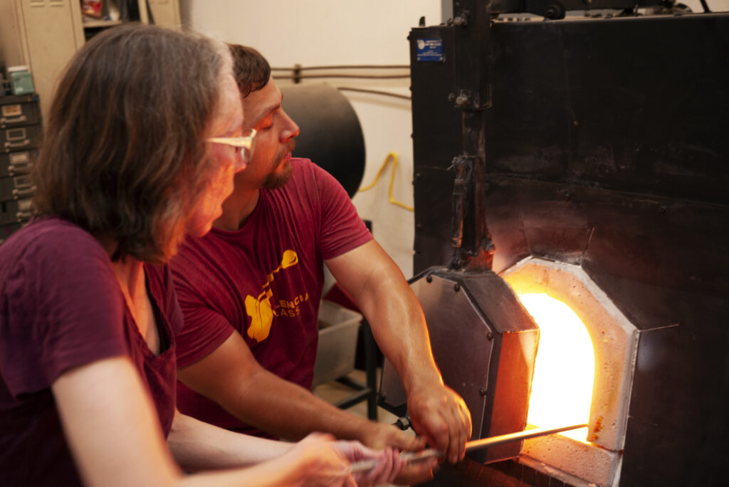 students glassblowing during glass