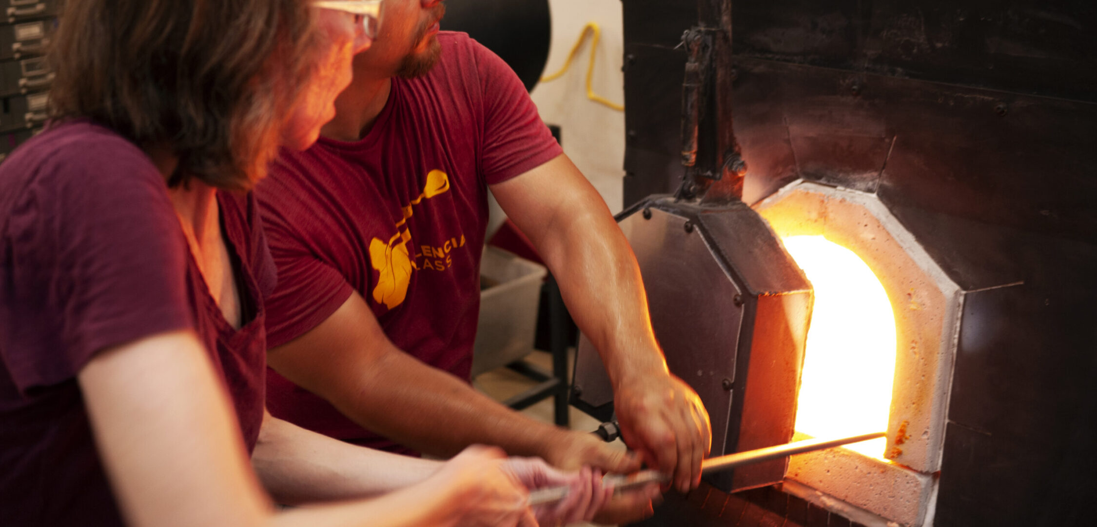 students glassblowing during glass